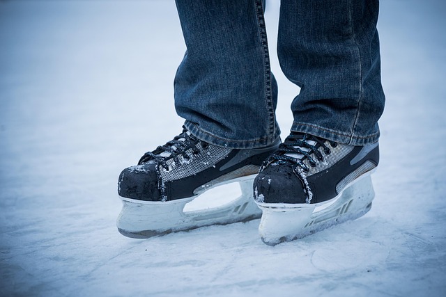 coach explaining skating basics to small group at ice rink